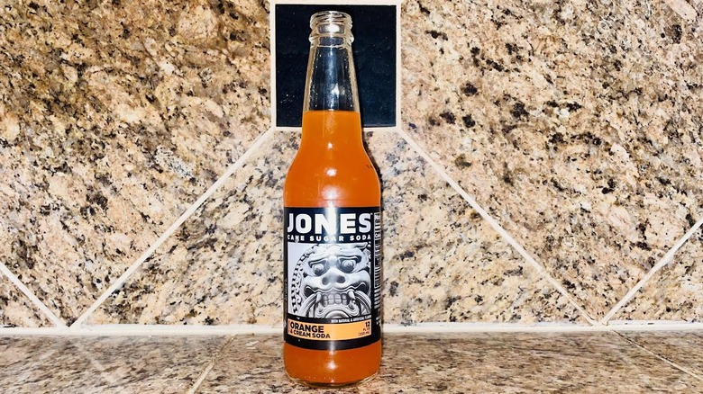 Glass bottle of Jones Orange Cream Soda on marble counter
