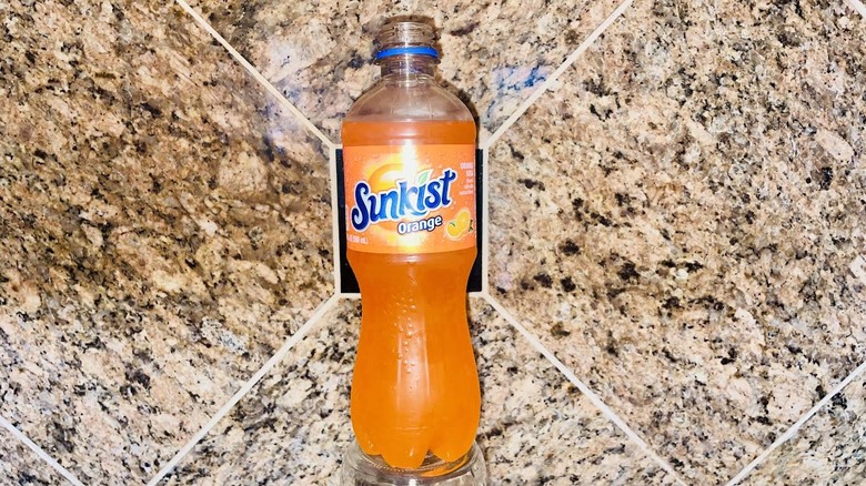 Bottle of Sunkist Orange Soda on a marble counter