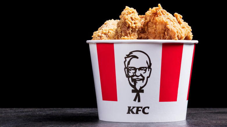 A KFC chicken bucket on a black background