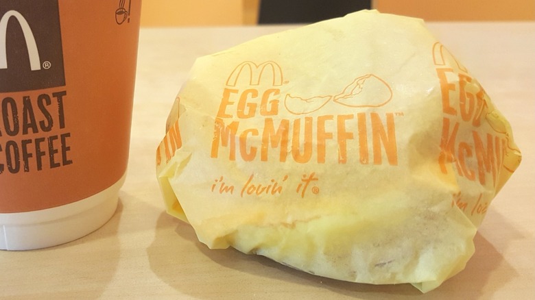 A wrapped Egg McMuffin and coffee