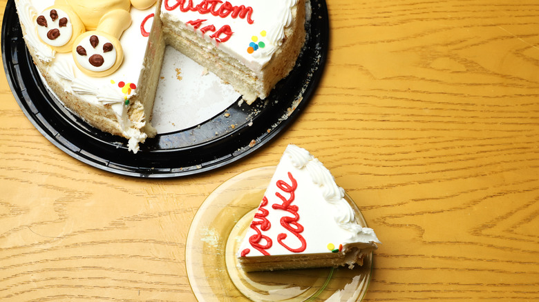 Sliced piece of cake alongside remaining cake