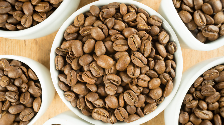 Bowls of blonde espresso roast coffee beans.