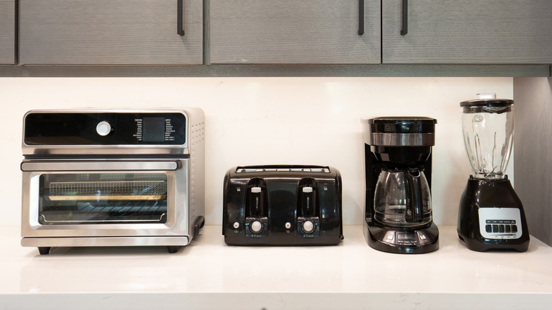 black and steel appliances on a white counter