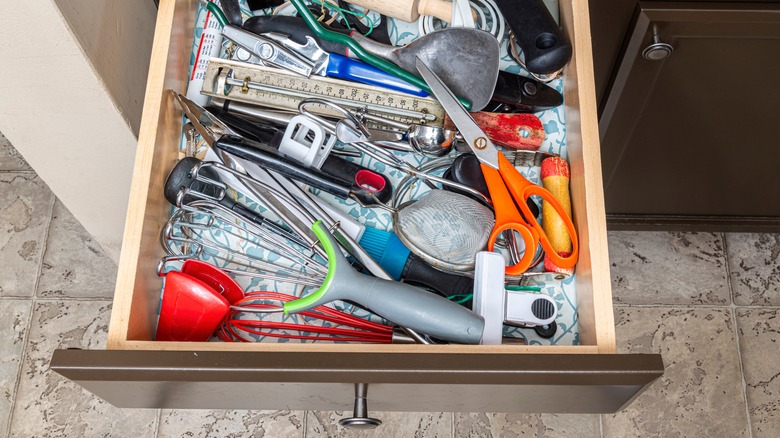 A cluttered kitchen junk drawer