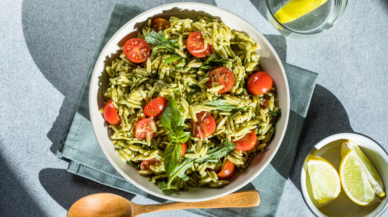 A bowl of orzo salad on a table.