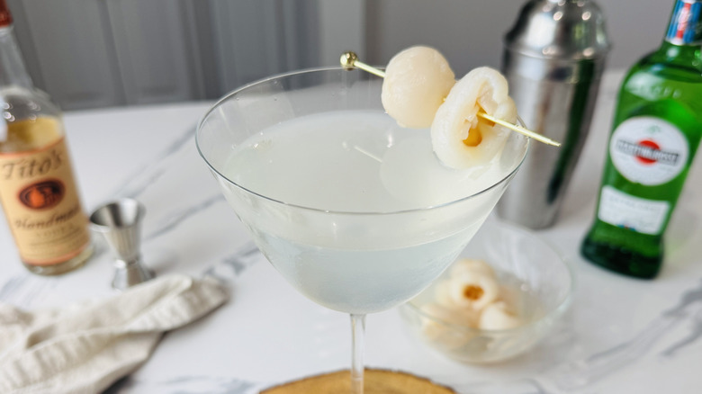 closeup of lychee martini in glass with lychee garnish