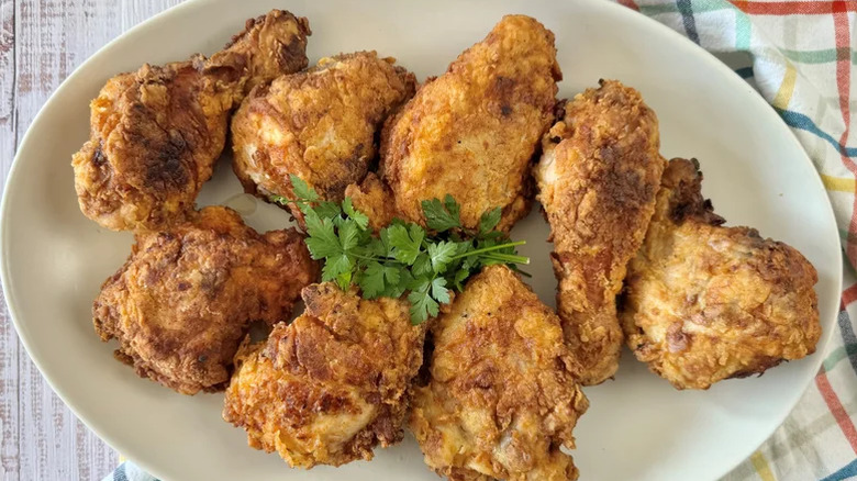 Fried chicken on a plate with herbs