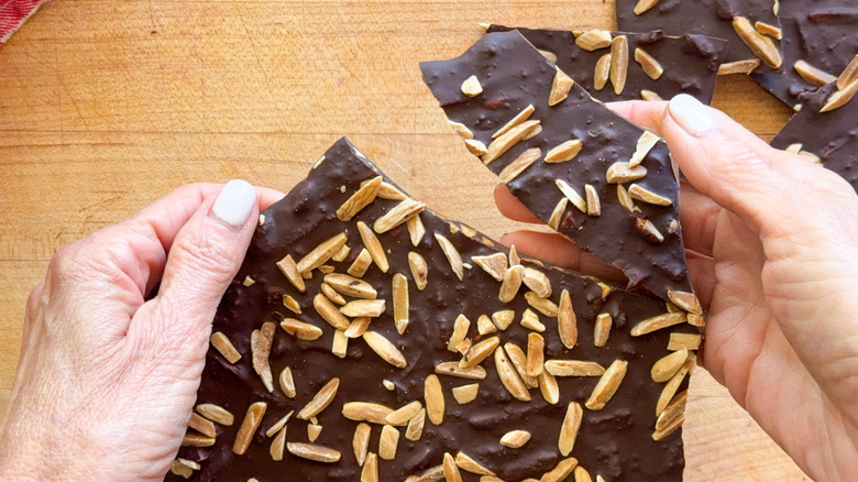 hands breaking chocolate