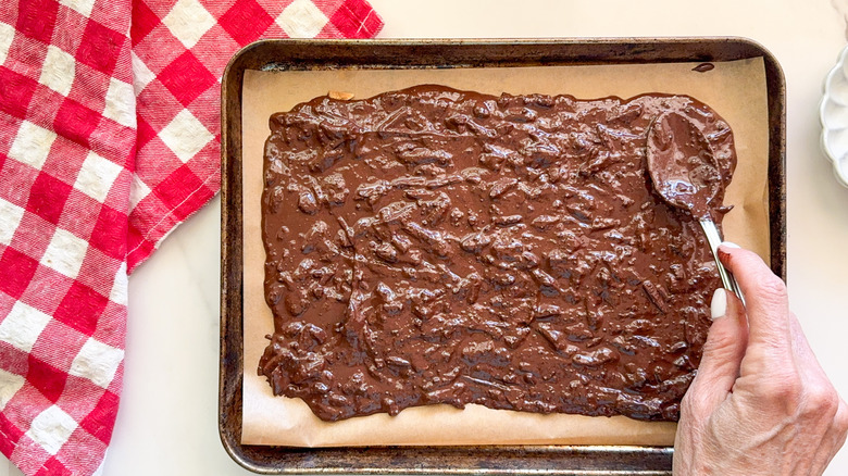 hand spreading out chocolate mixture