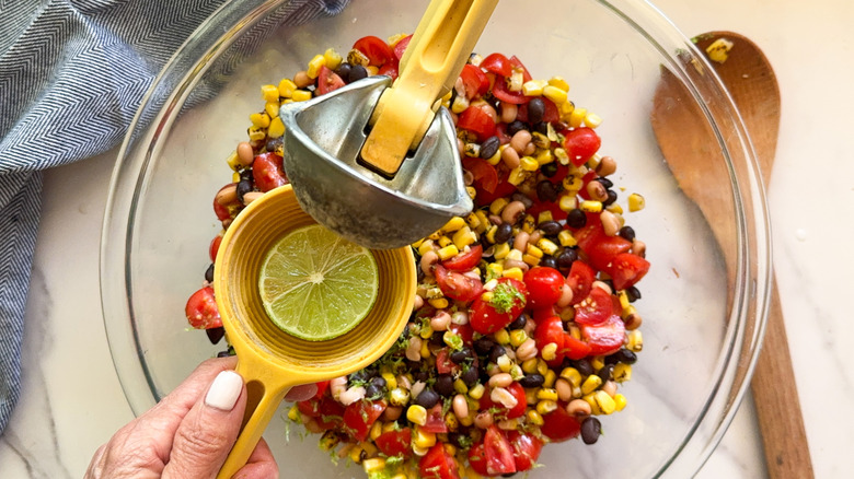 hands holding juicer over bowl
