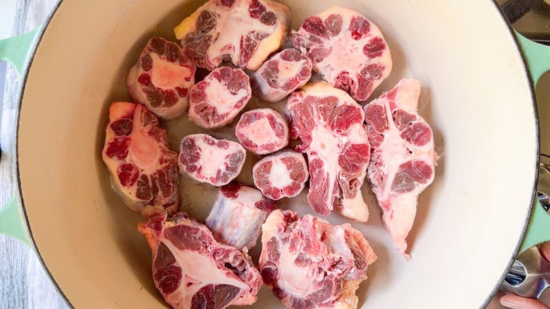 Crosscut beef shanks in Dutch oven on stovetop