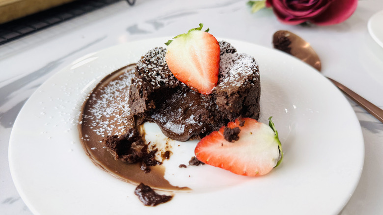 Chocolate lava cake with strawberries on plate