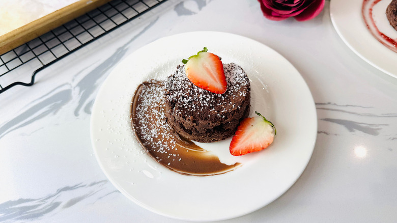 Chocolate lava cake on plate with strawberries