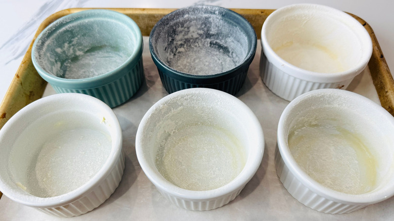 Floured ramekins on baking sheet
