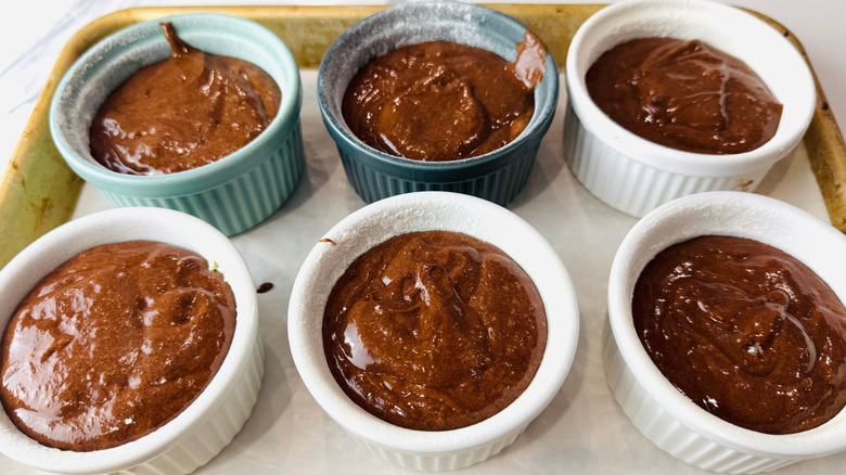 Unbaked chocolate cakes in ramekins