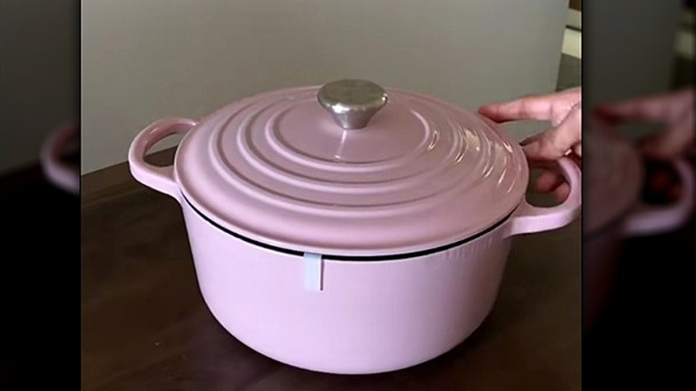 Le Creuset chiffon pink Dutch oven on countertop.