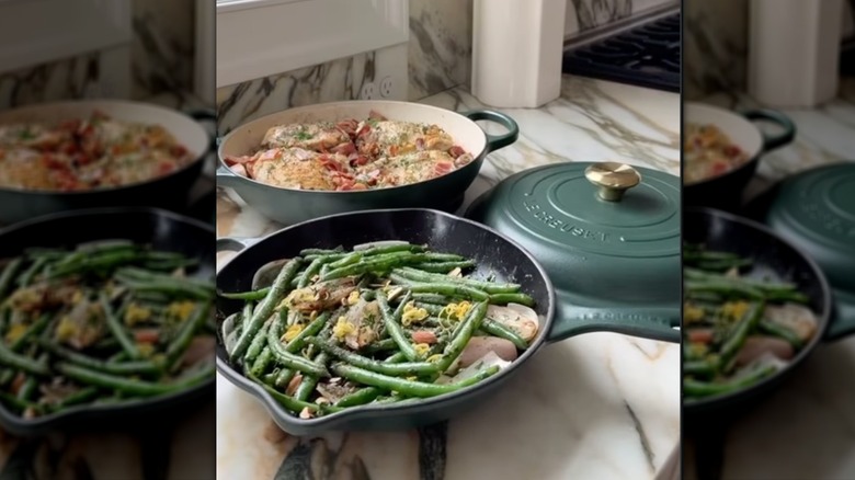 Forêt le Creuset cookware displayed with food on countertop.
