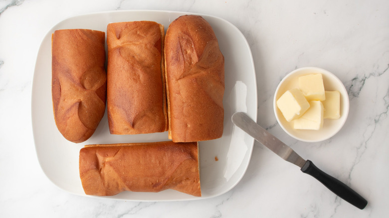 French bread pieces on plate next to bowl of butter