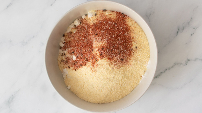 Cornmeal and Cajun seasoning in bowl