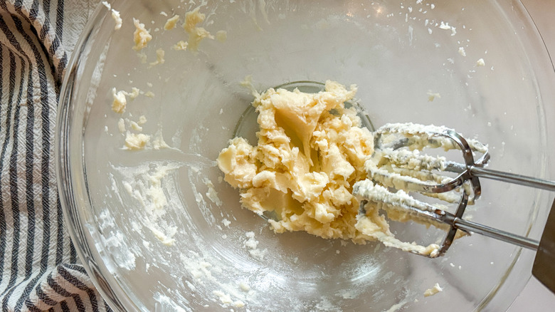 mixer beating butter and sugar in bowl