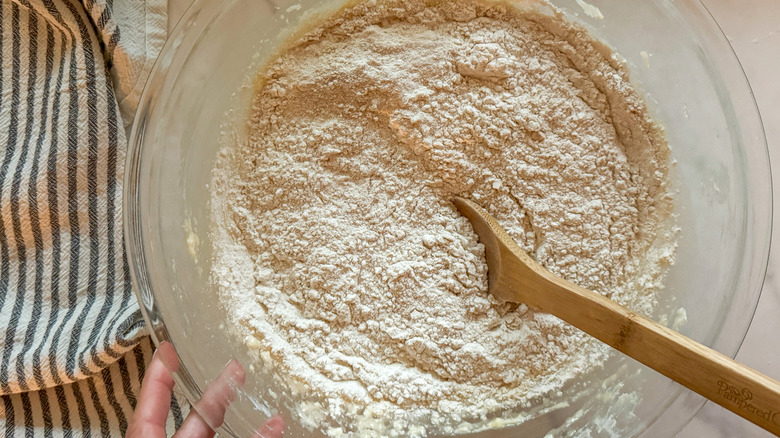 dry pancake bread batter in bowl with wooden spoon