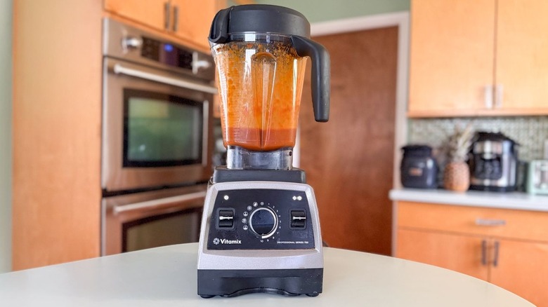 Blended honey bourbon BBQ sauce in high-speed blender on countertop