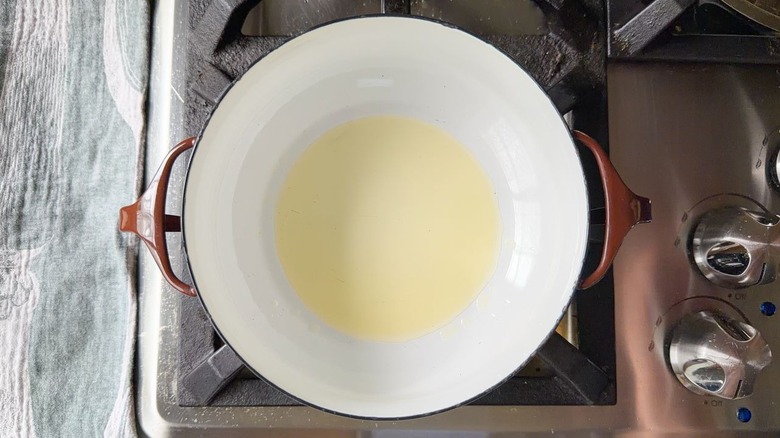 Avocado oil heating in pot on stovetop