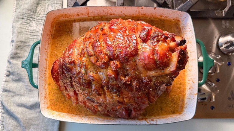 Miso and maple-glazed ham in roasting pan on stovetop