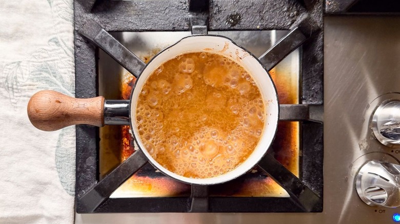 Miso and maple glaze simmering in saucepan on stovetop