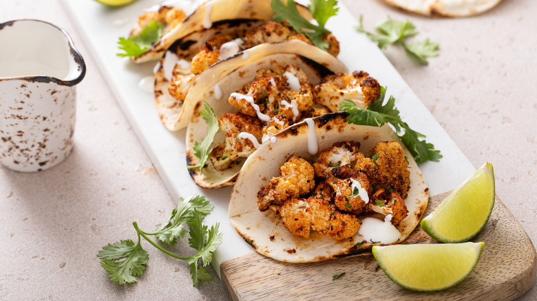 cauliflower tacos served with lime wedges