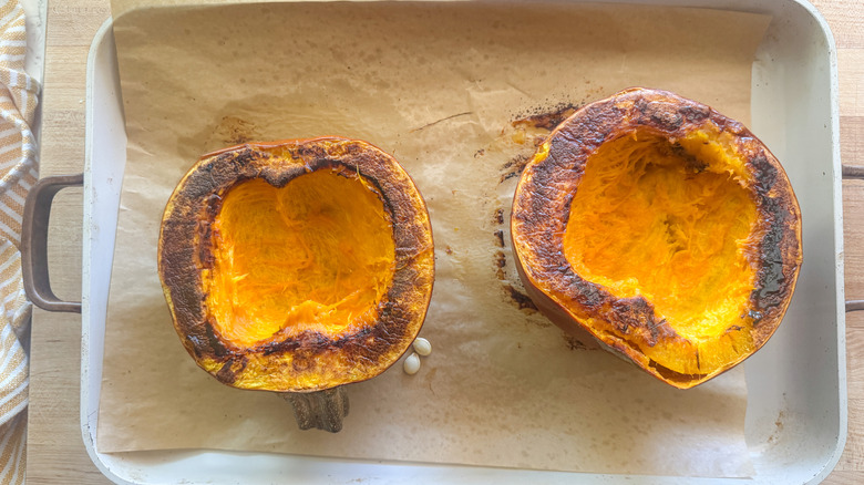 pumpkin halves on baking sheet