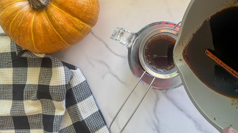 pouring the syrup through strainer