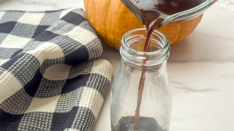 pouring syrup into bottle