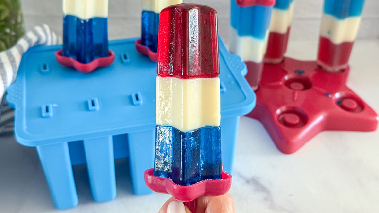 hand holding rocket pop