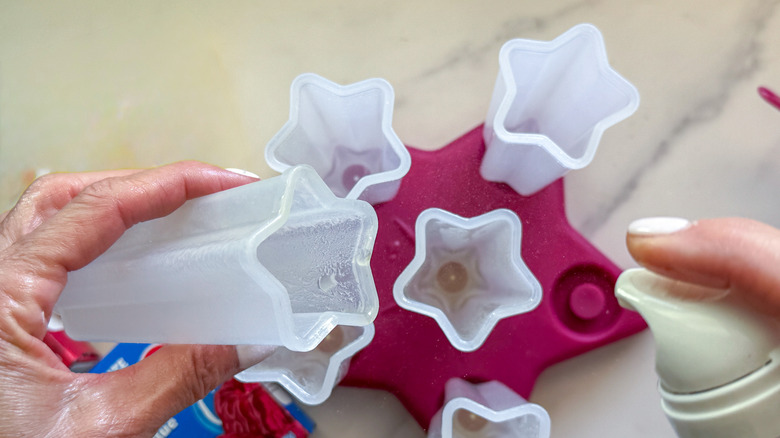 hand spraying inside of mold