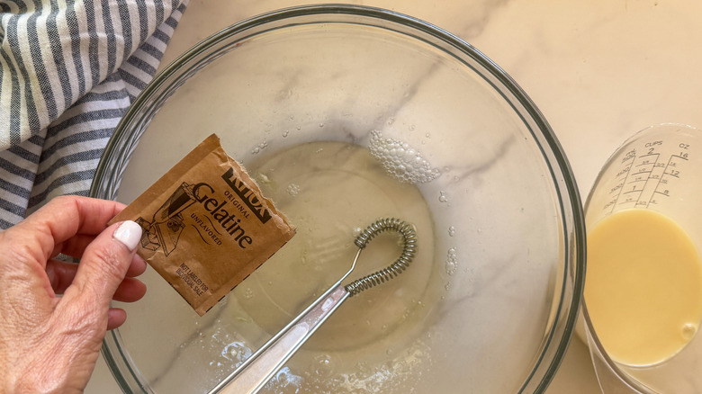 hand adding gelatin packet