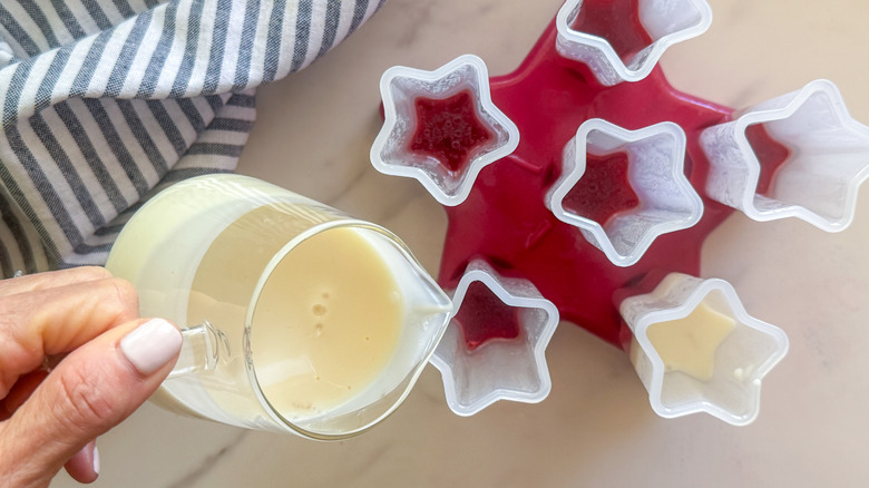 hand pouring in the white mixture