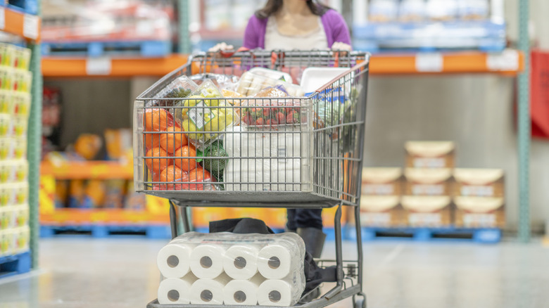 Woman pushing large shopping cart