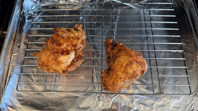 Fried chicken pieces on wire rack