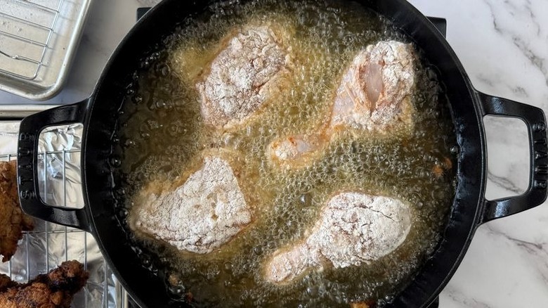 Chicken frying in large skillet