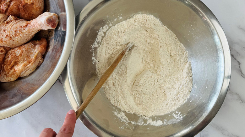 Spoon mixing flour in bowl