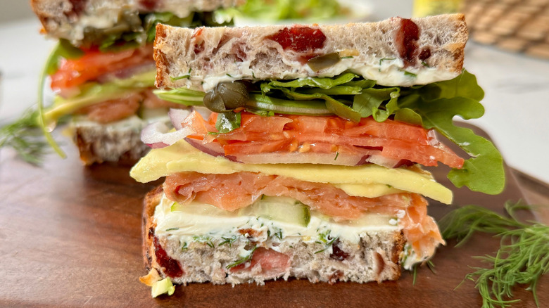 Smoked salmon sandwich on cutting board
