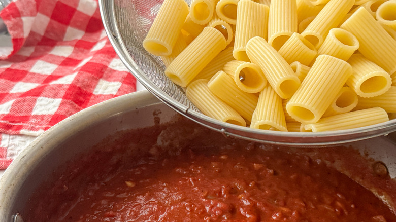 adding rigatoni to pan
