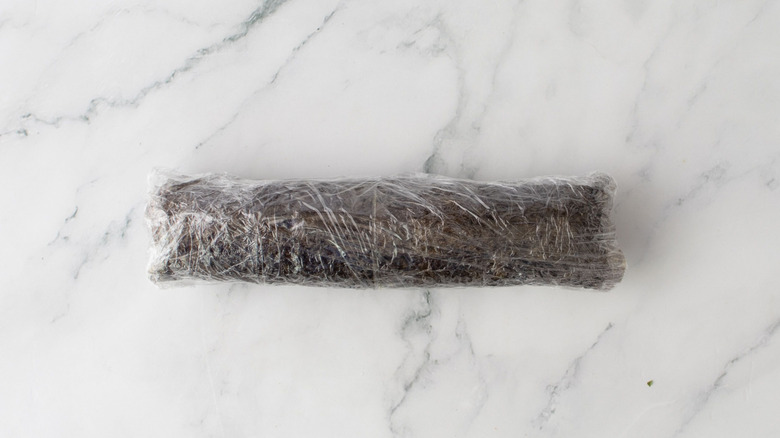 Sushi roll wrapped in plastic