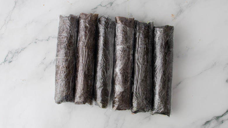 Sushi rolls wrapped in plastic