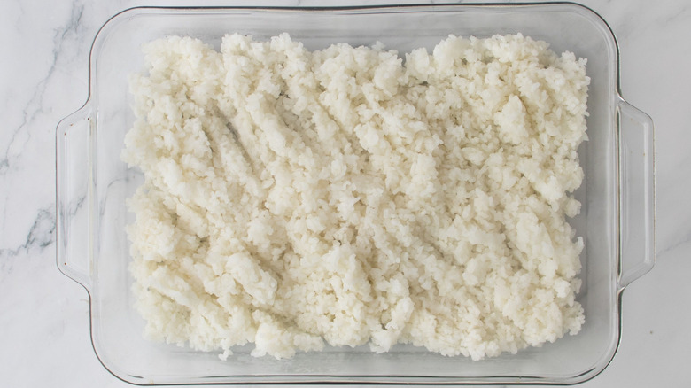 Layer of rice in casserole dish