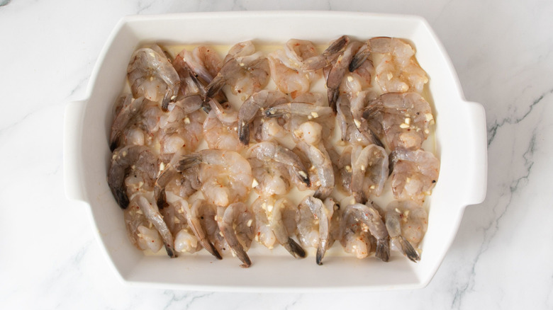 Raw shrimp arranged in casserole dish