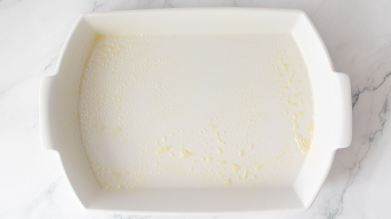 Greased casserole dish on countertop