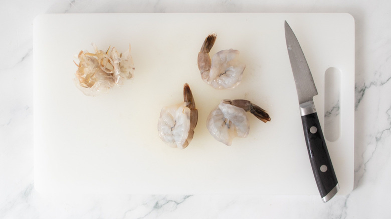 Butterflied shrimp on cutting board