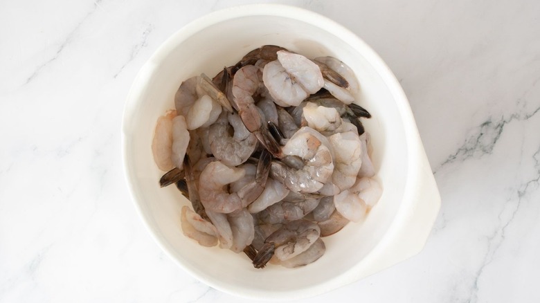 Raw butterflied shrimp in bowl